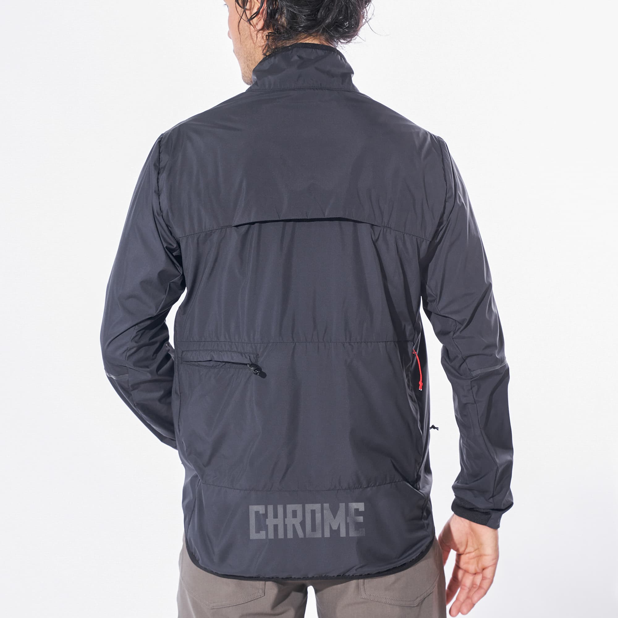 Lightweight packable wind breaker in black worn by a man back view