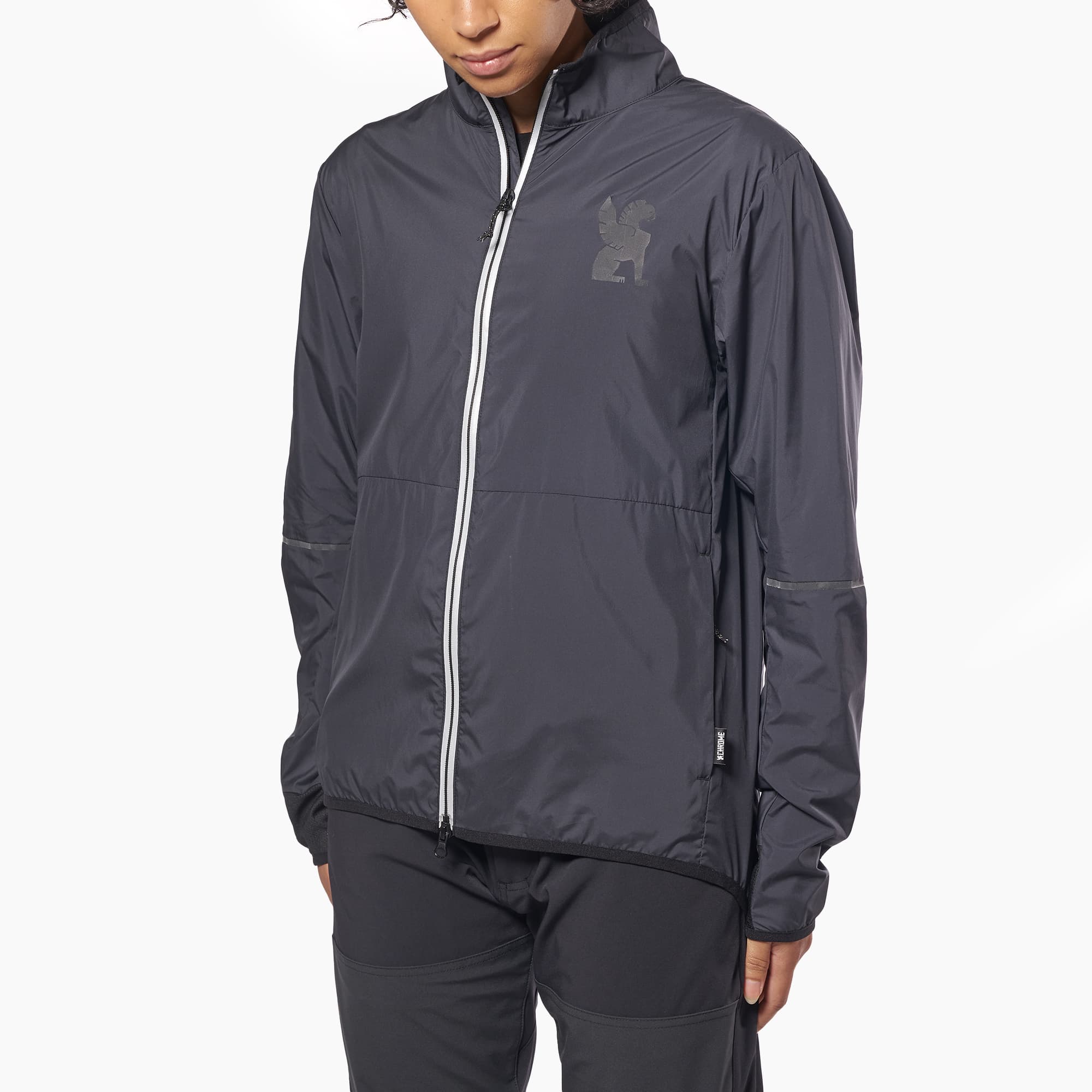 Lightweight packable wind breaker in black worn by a woman