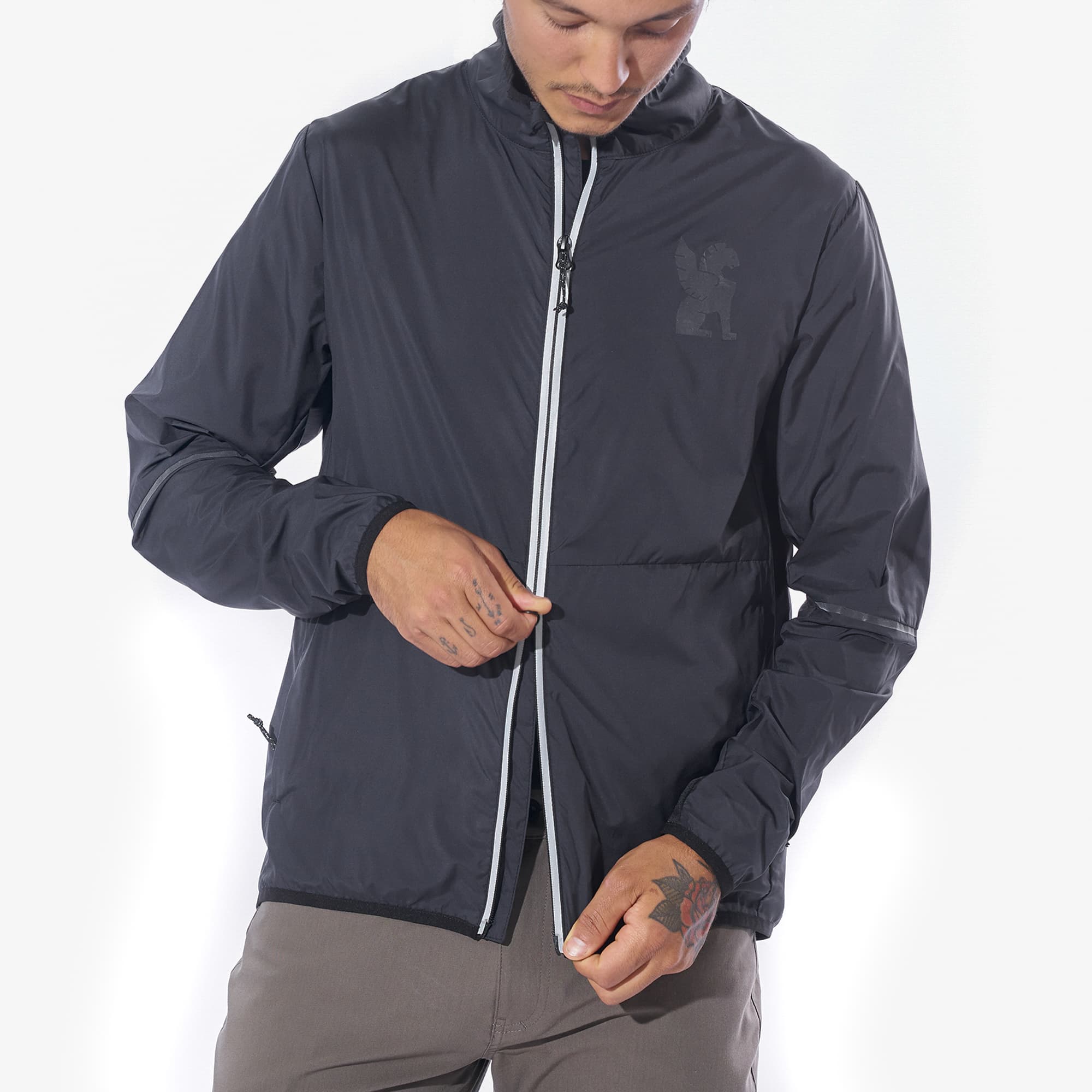 Lightweight packable wind breaker in black worn by a man